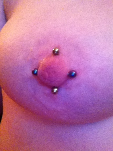 Double Nipple Piercing (Iron Cross) Front View